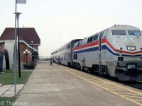 The last VIA-Amtrak "International" from Toronto to Chicago, lead by P42 32, is shown stopped at Sarnia station before entering the tunnel to the USA. On the left, note comparative frames of old and new tunnel sections on display on the station grounds.
