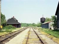 Once upon a time this was one busy railroad, with long grain trains passing thru town regularly. This glimpse of 40 years back shows the former "industrial" area in its' last years. Note the old steam era watertower.I believe it is still there, but nothing else is. The station was saved by a 'Snell' family which purchased the structure and had it moved in 1980 to the Old Mill Complex down on Huron County road 4 where it was to be a commercial establishment. The station had been built around 1907 when the original line, the Guelph & Goderich, pushed thru to Lake Huron. Track in it's last years was part of the CPR, and it was silenced and taken up in the 1990s. I tried to duplicate this image around 2005 but the change is so much that it is another Time Machine opportunity that has been lost to the passage of the years. Yes, thats my car back there. I should have moved it.