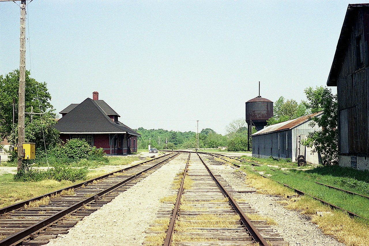Once upon a time this was one busy railroad, with long grain trains passing thru town regularly. This glimpse of 40 years back shows the former "industrial" area in its' last years. Note the old steam era watertower.I believe it is still there, but nothing else is. The station was saved by a 'Snell' family which purchased the structure and had it moved in 1980 to the Old Mill Complex down on Huron County road 4 where it was to be a commercial establishment. The station had been built around 1907 when the original line, the Guelph & Goderich, pushed thru to Lake Huron. Track in it's last years was part of the CPR, and it was silenced and taken up in the 1990s. I tried to duplicate this image around 2005 but the change is so much that it is another Time Machine opportunity that has been lost to the passage of the years. Yes, thats my car back there. I should have moved it.