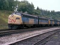 One didn't always see a combination of power like this on a weekend eastbound #76, but the good news was anything was possible so hanging around for this train on a Sunday late afternoon was pretty much a "must". About to enter the CN Oakville Sub around 1730 this particular light overcast day was CN 6516, 6620, 6791 and 6787. It was nice to see an A-B-A-A set, but even better that there was a bit of cloud. This image would have been right into the setting sun otherwise. I'm disappointed I did not log a car count. Incidentally, the close track, the 'helper' track from steam days, has since been removed.