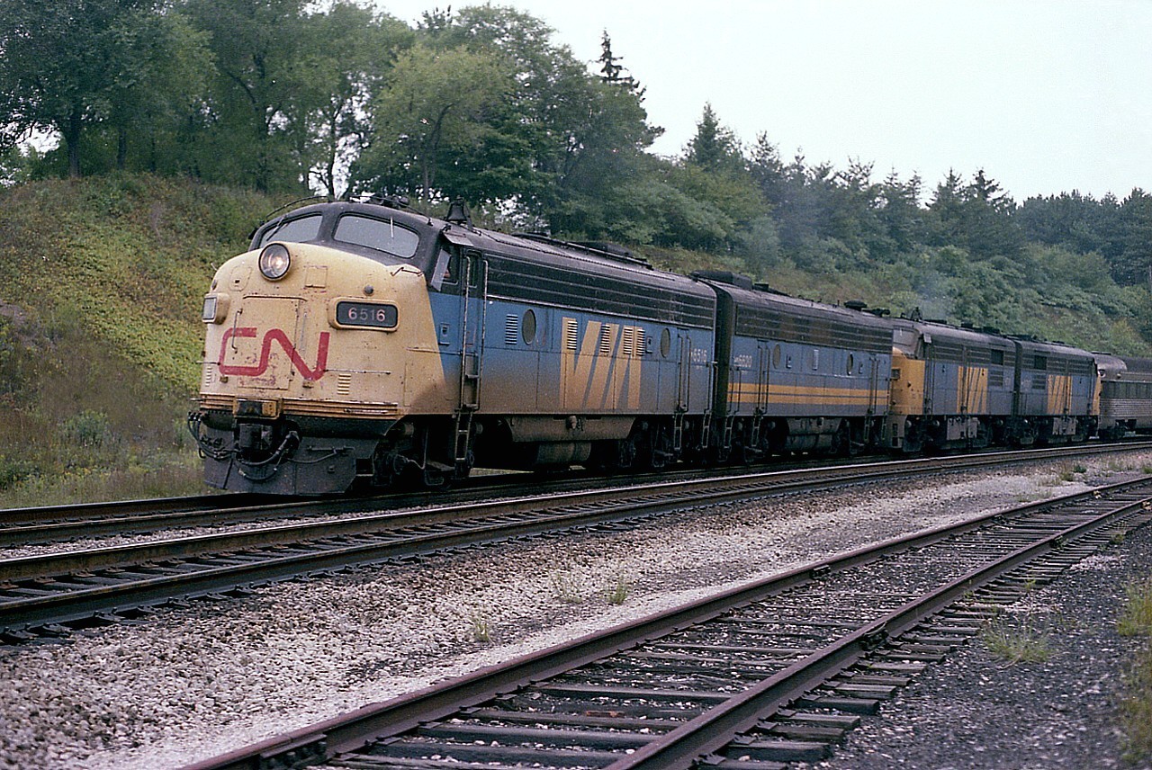 One didn't always see a combination of power like this on a weekend eastbound #76, but the good news was anything was possible so hanging around for this train on a Sunday late afternoon was pretty much a "must". About to enter the CN Oakville Sub around 1730 this particular light overcast day was CN 6516, 6620, 6791 and 6787. It was nice to see an A-B-A-A set, but even better that there was a bit of cloud. This image would have been right into the setting sun otherwise. I'm disappointed I did not log a car count. Incidentally, the close track, the 'helper' track from steam days, has since been removed.
