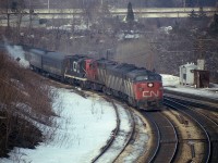 Train #75 I marked in my notes as "late" as this 14 car weekend westbound comes off the Oakville onto the Dundas Sub at Bayview in March of 1978. Typical mix of power is CN 6781, 6625, 3124 and 4102. This train typically passed thru Bayview around 1615; on this day it was 1645.