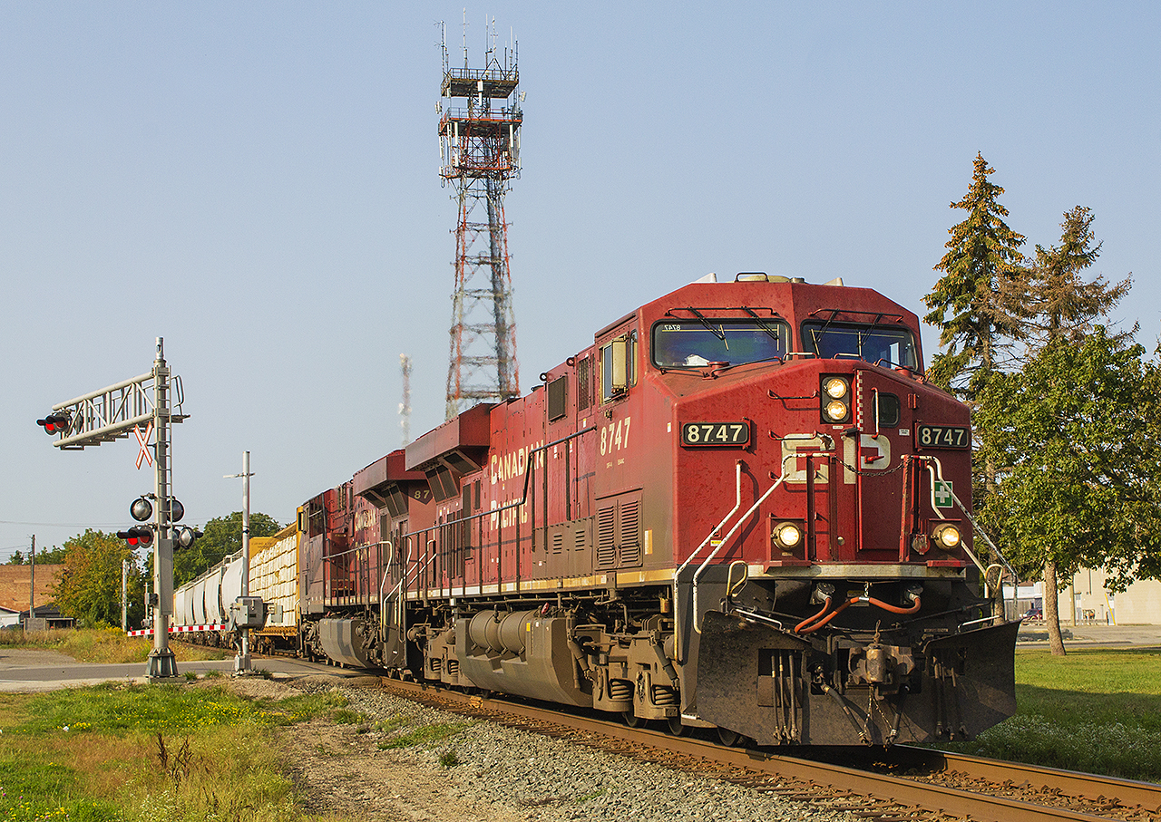 THE RARE MORNING EASTBOUND...  It is a beautiful sunny morning in downtown Chatham, where 240 makes it's way along one of the tightest rail corridors with numerous level crossings. Led by CP 8747 and 8717, it is about at the half way mark already having crossed or still blocking (west to east) Bloomfield Road, Keil Drive, Merritt Avenue, Inshes Avenue, Lacroix Street, West Street, Raleigh Street, Jeffrey Street, Queen St., Centre Street and finally Wellington Street in the foreground. Surprisingly, this train still has yet to cross William Street, the King and Adelaide intersection, Colborne and Princess Streets. It will exit Chatham as it crosses Longwoods Road and Prince Albert Drive.