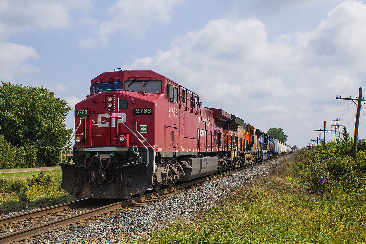 MORE "FOREIGN POWER IN ONTARIO (FPON)", as CP 9768 picks up speed with an unidentified BNSF unit and NS unit # 7231 trailing, after a meet with an eastbound train at Bloomfield Road in Chatham.