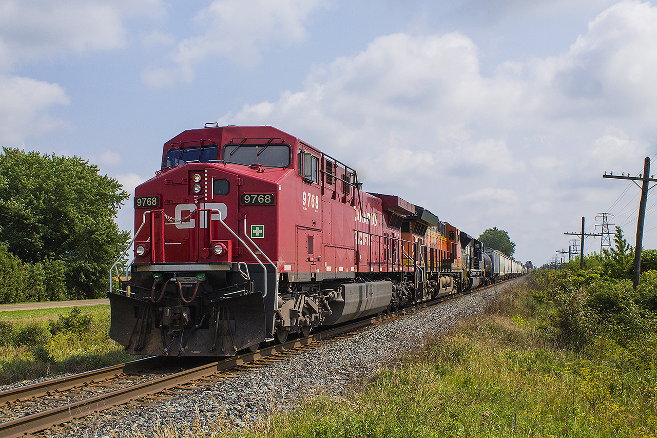MORE "FOREIGN POWER IN ONTARIO (FPON)", as CP 9768 picks up speed with an unidentified BNSF unit and NS unit # 7231 trailing, after a meet with an eastbound train at Bloomfield Road in Chatham.