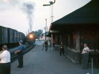 The "Boys down at the Depot" gather to observe an evening meet at Canadian Pacific's Galt Station, with CPR 5419 heading a westbound meeting an eastbound freight in 1959.