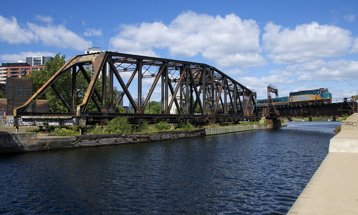 About 75 minutes before its 1545 departure time from Central Station, VIA 67 backs up with VIA 6443 pushing the train over the Lachine Canal. At left is the out of use CN swing bridge.