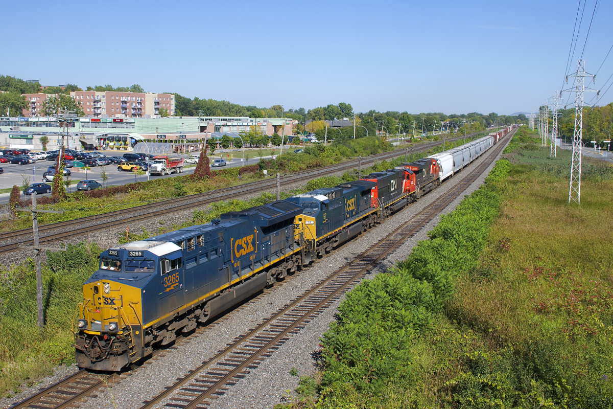 CN 327 has quite a bit of power, with ET44AC CSX 3265, repainted AC4400CW CSXT 57, SD60 CN 5440 & ES44DC CN 2335 up front as it passes MP 14 of CN's Kingston Sub on a sunny afternoon.
