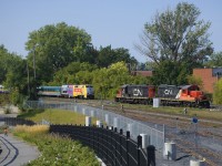VIA 60 has P42DC class leader VIA 900 as it approaches a pair of stopped GP9's (CN 7032 & CN 7075) at the western end of Pointe St-Charles Yard. At left is the new railfans park.
