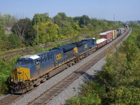 CN 327's conductor waves from the lead unit as the train passes a pedestrian overpass in Beaconsfield. Unfortunately the lead unit had died just a bit east of here; the train would crest the ruling grade west of here at 9 mph before the unit was brought back online at Coteau.
