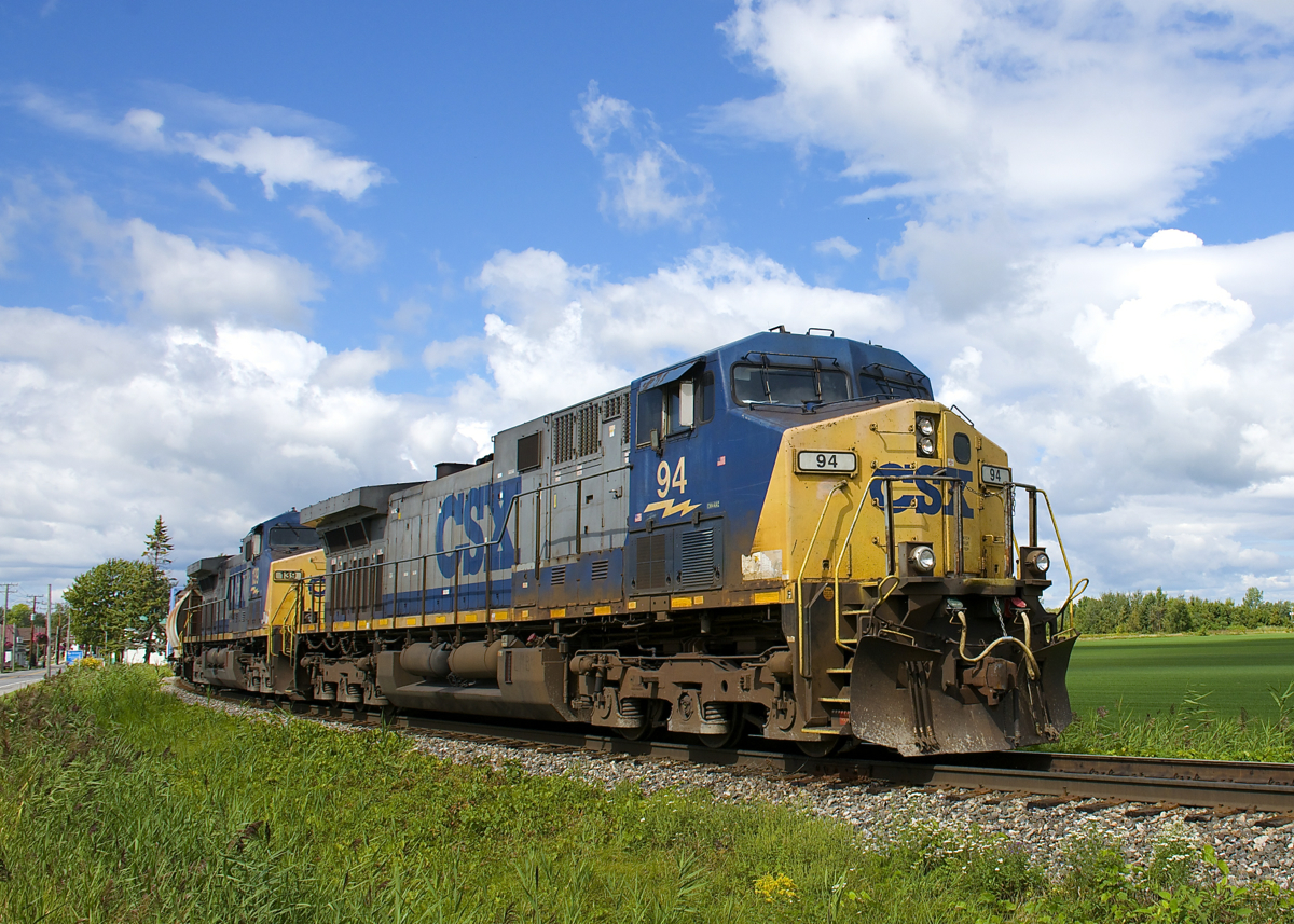 A pair YN2 AC4400CW's (CSXT 94 & CSXT 139) operating elephant style are the power on a 320-axle CN 327 which is seen passing on the Valleyfield Sub wye at Coteau.