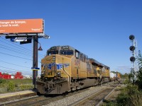 <b>In Canada for the third time.</b> For the third time in a bit over a week, a pair of UP GEVO's (UP 5479 & UP 5481) came into Montreal on CP 142 and left on CP 143. Here CP 143 is passing through Lachine Station with those two units on a gorgeous fall afternoon.