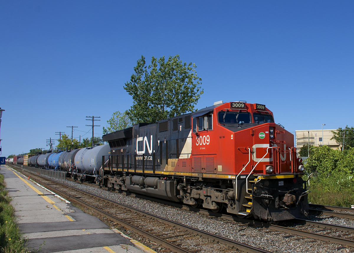 CN 3009 leads CN 368 through the VIA Dorval Station, with CN 2311 operating mid-train.