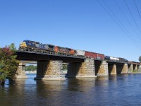 Twenty-five year old Dash8-40CW CSXT 7836 and forty-three year old GP38-2W CN 4809 are still earning their keep on the main line, as they lead CN 327 over the Ottawa River and off the island of Montreal.
