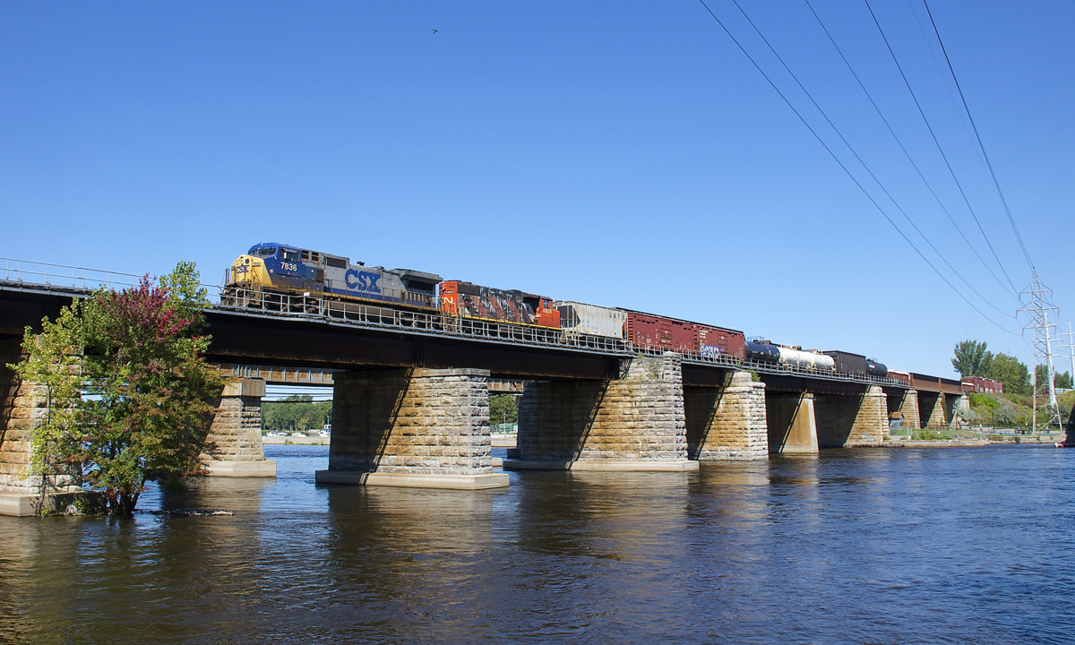 Twenty-five year old Dash8-40CW CSXT 7836 and forty-three year old GP38-2W CN 4809 are still earning their keep on the main line, as they lead CN 327 over the Ottawa River and off the island of Montreal.