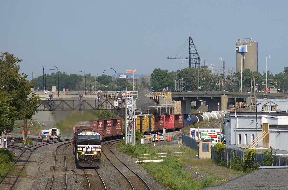 NS 4018 is a GE AC44C6M that was rebuilt from Dash9-40C NS 8788 earlier this year at GE's Forth Worth plant, and it's still looking fairly fresh as it leads CN 529 through Montreal West, with SD70M NS 2599 trailing. It is passing under a classic signal gantry which will be replaced sometime during the next year or two, if not sooner.