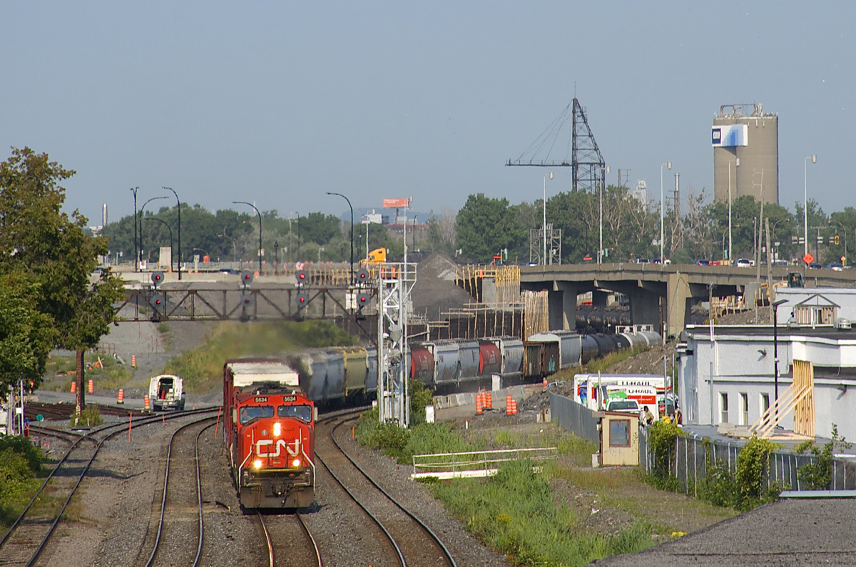 CN 527 with CN 5634 & CN 2000 for power is through the s-curve at Turcot West, a view only possible since a tunnel was demolished here in 2016. Soon the view will change again, with the tracks being moved around the curve at left.