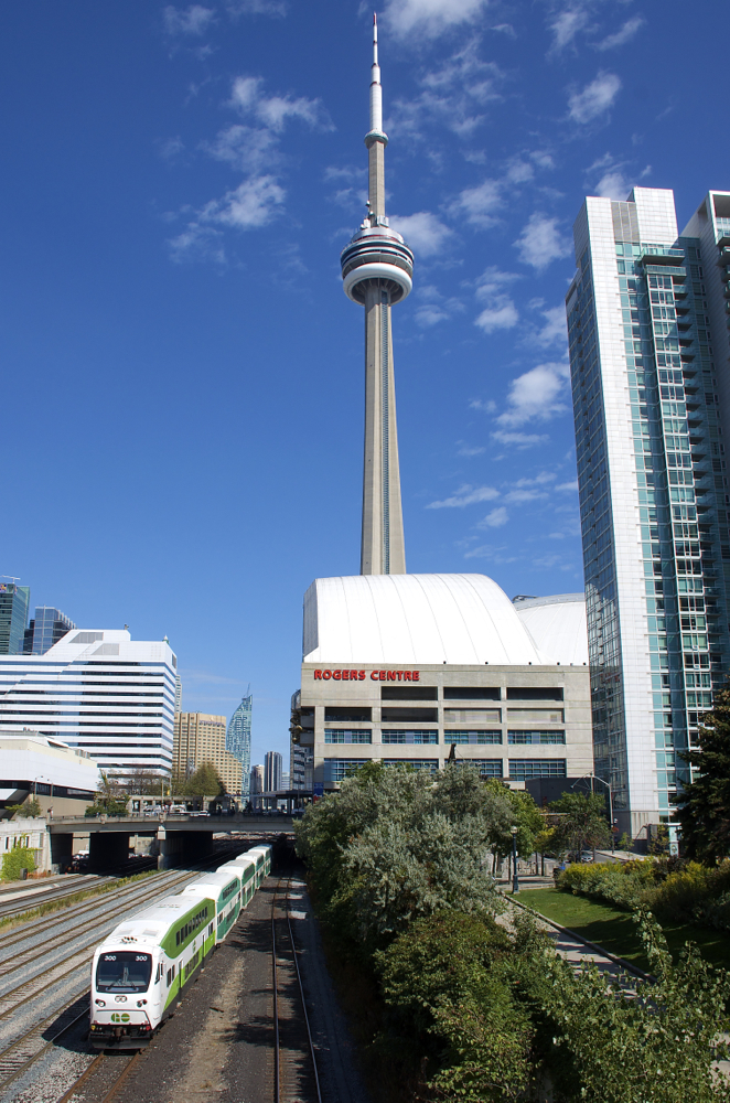 Cab car GOT 300 leads a westbound out of Union Station and past two Toronto icons: The Rogers Centre (formerly the SkyDome) and the CN Tower.