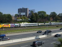 VIA 73 for Windsor is westbound on the Oakville Sub with a slightly unusual consist of three stainless steel cars with a single LRC car second out. Leading is wrapped VIA 906. In the foreground is the the Queen Elizabeth Way highway.