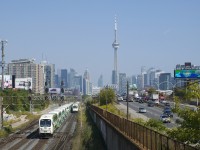GO Transit has seen an influx of new cab cars over the past year or two, here two meet near Exhibition Station, with GOT 334 at left heading east and GOT 346 at right about to head west. In the background is Toronto's skyline.