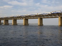 AMT 1342 leads a 7-car AMT 76 towards the island of Montreal on a humid morning.
