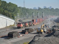 The City of Montreal seems perpetually under construction.  One of the biggest projects is the rebuild of the Turcot Interchange.  It requires the relocation of the Canadian National tracks as a key part of the project.

All four tracks will be relocated through Turcot.  To date only one track is open.  That track is the siding known as Track 29 that was/is used for block swapping.  The train is CN #149, the Port of Montreal to Chicago container train, and its power backed into the new track to retrieve cars left for it by #121 the Halifax to Toronto container train.
 
Complete cut-over to the new line is scheduled for August 2018.