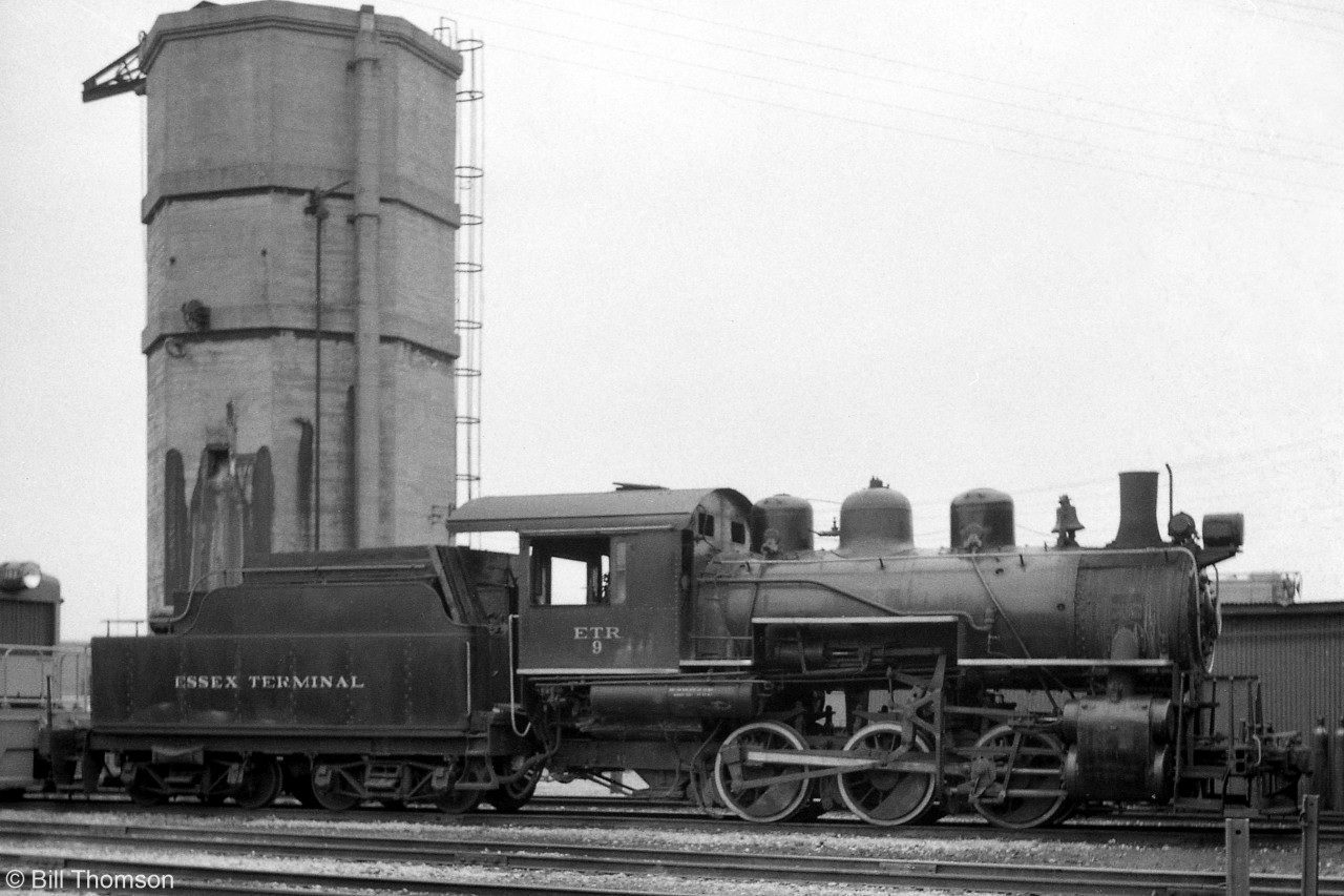Essex Terminal Railway #9, their 0-6-0 built by MLW in 1923, sits at the Windsor engine terminal coupled up to a switcher unit in 1961. ETR 9 was retied in 1963, and set aside for preservation in a planned Ontario rail museum that never came to fruition. It was leased to the Southern Ontario Locomotive Preservation Society (SOLRS) in St. Thomas for many years, and is currently owned by them.