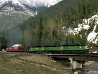 CP was considering buying GE power. During a test a trio of GE Built BN Dash 8's with dynamometer car in tow descends the west slope of Rogers Pass.