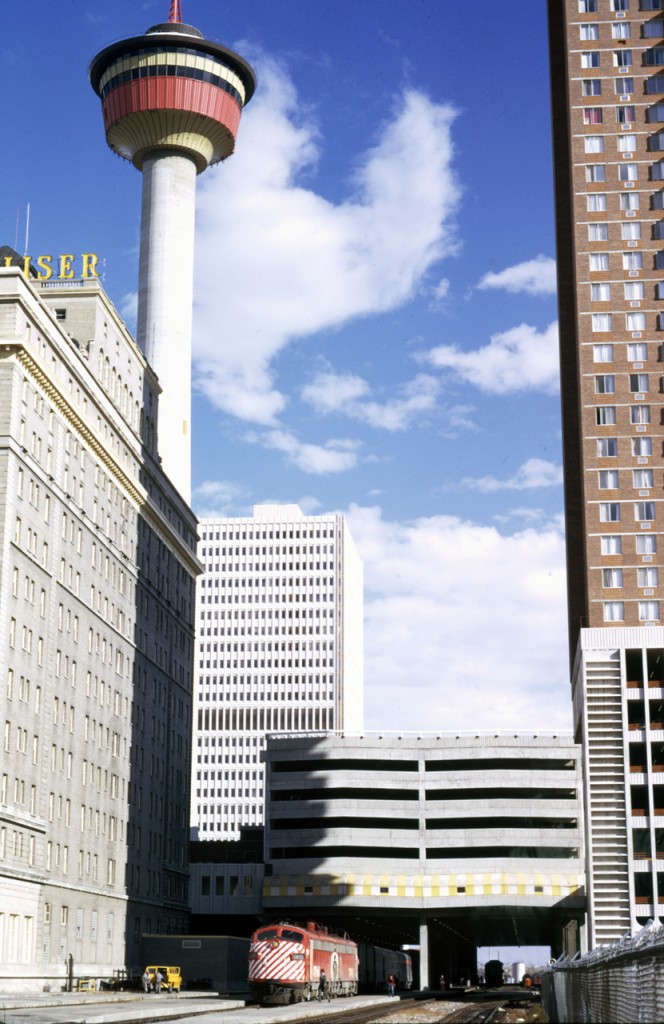 The Canadian pauses under the Calgary Tower.  On the left the CP's flagship hotel in Calgary, the Palliser can be seen.  Now there are no passenger trains in Calgary and CP hotels are branded the faceless Fairmont name.