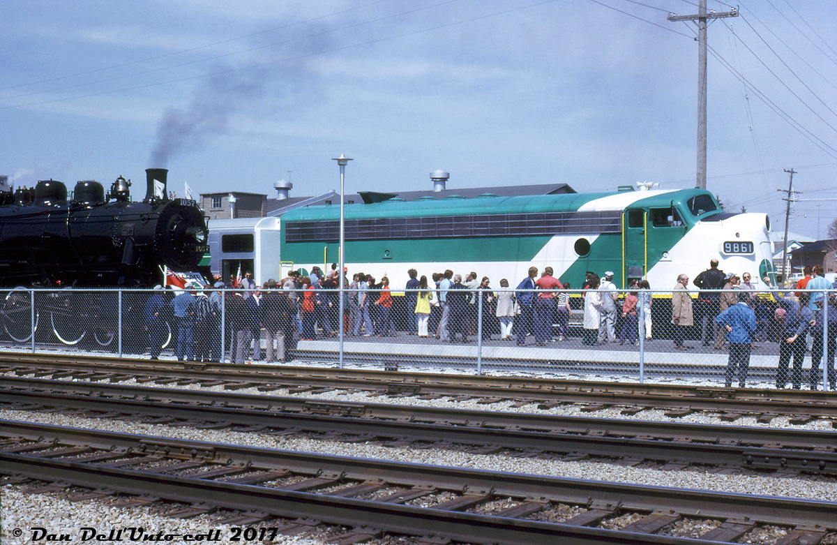 It's April 27th 1974, and crowds are teaming the new GO Transit platforms at Georgetown Station for the inauguration of the new Georgetown line GO train service. Two trains were run that day from Toronto to Georgetown and back for the event: a typical GO train consisting of 10 Hawker-Siddeley single level cars lead by GP40-2W 9808 & APCU 9861 (a rebuilt ex-Ontario Northland FP7), and a steam-powered train of vintage heavyweight passenger cars lead by the Ontario Rail Association's 1912-built ex-Canadian Pacific D10h 1057, lettered for the Credit Valley Railway (the famed steam excursion star that's presently at the South Simcoe Railway).   Government and railway officials, passengers, and railfans are all present for the event, including then-Premier of Ontario Bill Davis, who would later climb up in the cab of 1057 and ceremoniously operate it from Brampton (his hometown and where he started his political career) to Bramalea GO station.  Reg Button photo, Dan Dell'Unto collection.