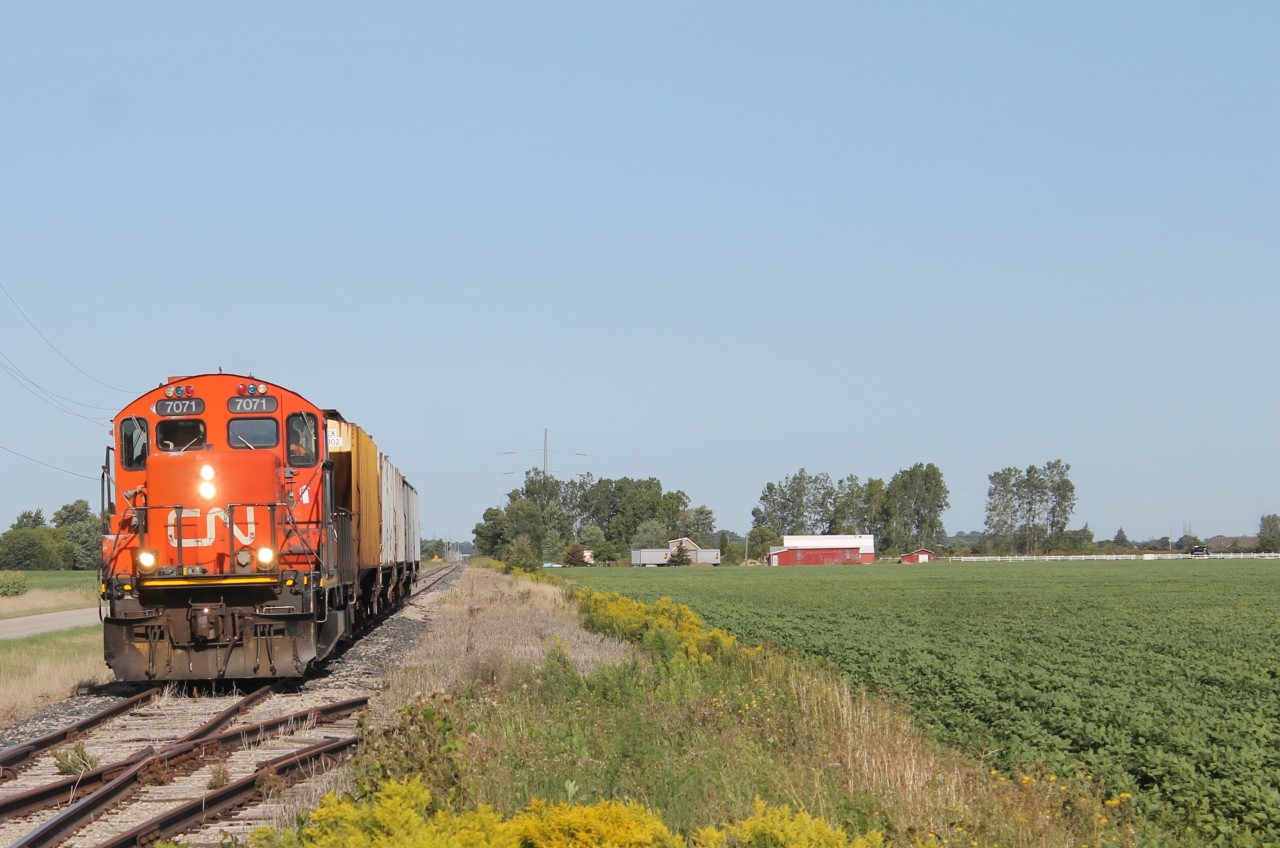 Here we see CN 7071 continuing down the line while passing an old siding. This siding has been discontinued as the rail from the switch track has been cut up slightly.