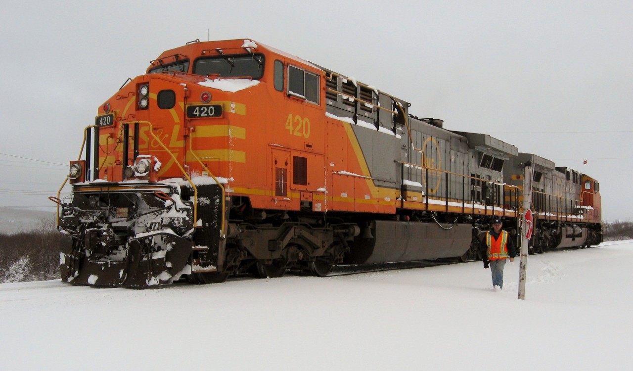 LABRADOR LINE. Engineer Joseph Hynes approaches the photographer to invite him into the warmth of the cab of AC4400CW #420 during the first major snow storm of the season. Joseph, a long time engineer with the QNS&L, was waiting on the mainline just outside Labrador City for clearance to bring the 420 and sister General Electric engine 422 back into the yard of the Iron Ore Company of Canada for a later run of ore to Sept-Iles.
It was the beginning of a wonderful friendship of two men, one a railroader and the other a railfan, who shared a passion for trains.