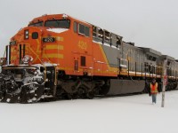 LABRADOR LINE. Engineer Joseph Hynes approaches the photographer to invite him into the warmth of the cab of AC4400CW #420 during the first major snow storm of the season. Joseph, a long time engineer with the QNS&L, was waiting on the mainline just outside Labrador City for clearance to bring the 420 and sister General Electric engine 422 back into the yard of the Iron Ore Company of Canada for a later run of ore to Sept-Iles.
It was the beginning of a wonderful friendship of two men, one a railroader and the other a railfan, who shared a passion for trains.