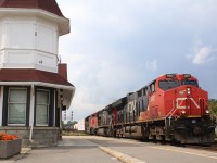 It's the first day of school and autumn is only a few weeks ahead as the sound of a school bell ringing in the distance. CN train 276 is seen passing a planter of orange mums at the shared VIA/GO station in Georgetown, the flowers almost seem symbolic of the fast approaching fall colours and unsettled weather seen in the distance, that will soon become so common. It won't be long now before we hear that feared "F" word, "flurries", LOL.