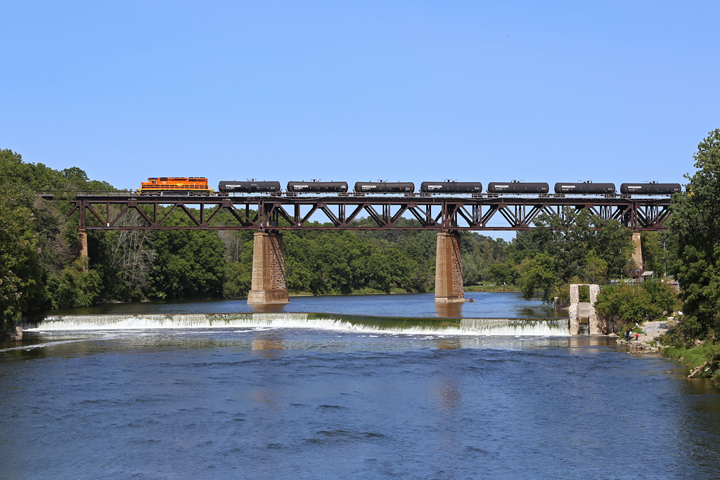 Making a rare daylight interchange run to CN at Paris the RLHH 3404 leads a bunch of Procor tank cars and one flat on the end over the Grand River in Paris, Ontario.  I'd been there to shoot VIA and stuck around to see if anything else showed up hitting the jackpot when this rolled out on the bridge.