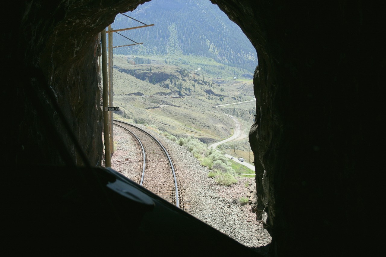 Descending Kelly Lake Hill on the BC Rail Lillooet sub, exiting one of three tunnels on the grade. It is quite a spectacular view on this warm summer afternoon. We will make a brief stop at Lillooet for a leg stretch, contact the RTC for track authority and continue south to Whistler.