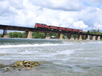NECR 3840 leads a five car ballast extra across the Grand River trestle in Caledonia, ON.

They're seen here returning to Hagersville to reload, after dumping in the Brantford area earlier in the afternoon