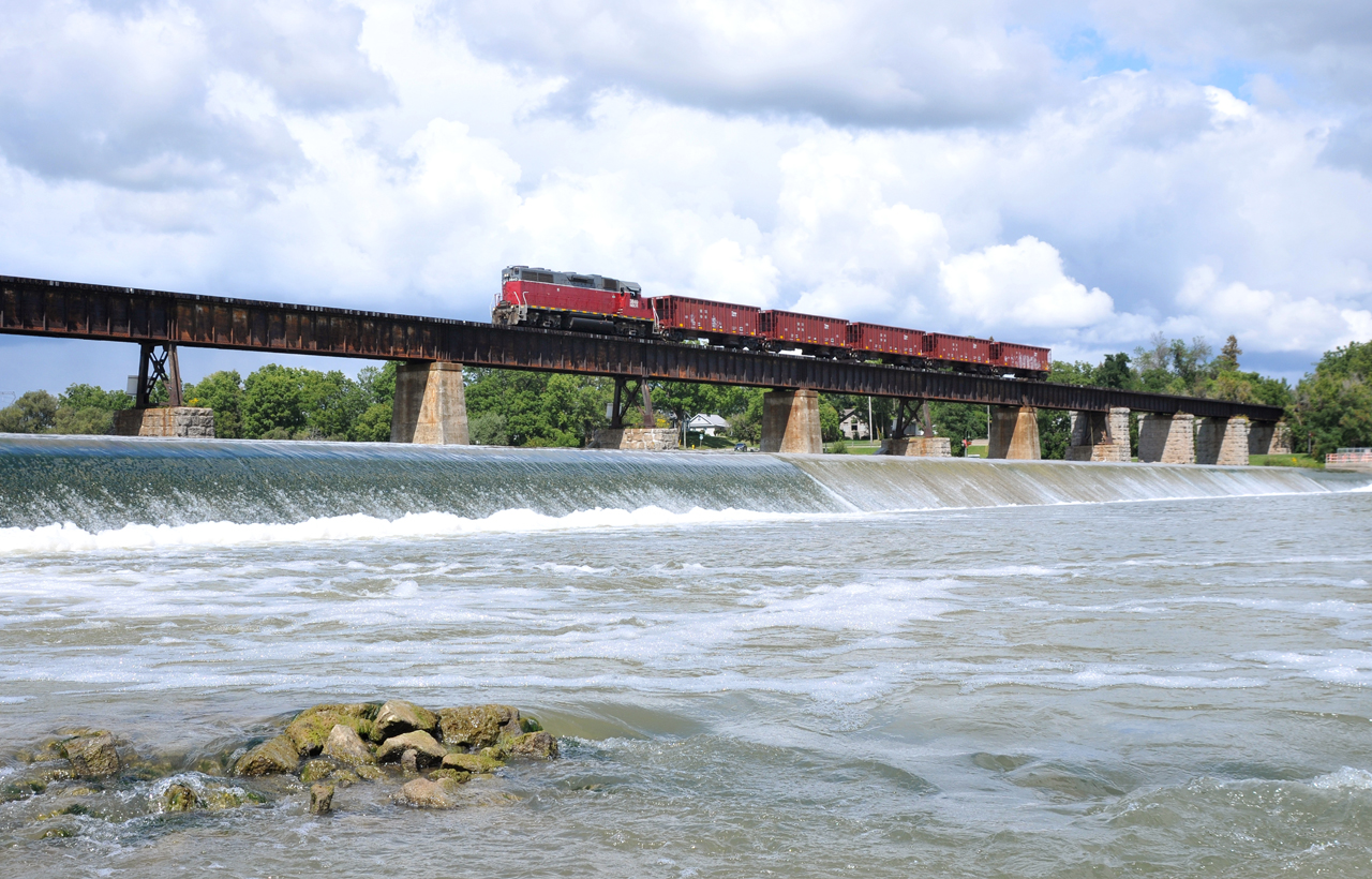 NECR 3840 leads a five car ballast extra across the Grand River trestle in Caledonia, ON.

They're seen here returning to Hagersville to reload, after dumping in the Brantford area earlier in the afternoon