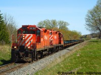 Ahh Beachville road - this road certainly has stories to tell - and hundreds of photographers to tell the story. Before OSR made railfans mad about trains on Beachville road, you'd visit here to chase the Frame Train - Train 141 was a predictable, Monday-Saturday early afternoon run. You could chase to Ingersoll, beyond that, good luck as they wasted no time to get back to St Thomas. Add to this movements TK21 and TK12 and Cami extras as required this line was good for about 4 to 6  CP movements a day, plus the two CN movements in Ingersoll. Not bad for a sleepy little Branchline eh?<br><br>
With a pair of GP9's this was a typical train - in this case consecutively numbered GP9's, clickty-clacking down the track with the crew less than an  hour from their home terminal. OSR President Jeff Willsie was often found on this job too when he still worked for CP.

