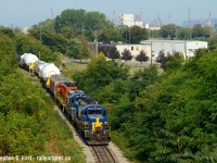 Reversing down the 1.2?% grade of "The Hole" - three engines are used to provide extra braking power for this very short and heavy train. All operable and 'on hand' four axle units were put together for this movement, which dropped these D9R loads beside Pier 14.
