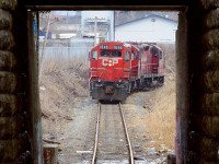 This underpass, carrying the CP ex TH&B Belt line under the CN Grimsby subdivision would have been constructed in 1900 if it was built when the Belt line was created. However the construction of these stone abutments (on this side only) screams 30-50 years older, appearing to be made of stone similar to other bridge abutments along the CN (ex Great Western/Grand Trunk) Grimsby sub. Could this have been built far earlier? Regardless, elegant looking abutments meet scummy, dirty, north end Hamilton, this is probably the roughest part of town, Beach Ave by Dofasco, I wouldn't advise going here at night but unlike the US it's probably not all that bad if you don't stand out. I recall there used to be a tavern/strip club type establishment (now demolished) that was known as a druglords paradise (anyone care to rekindle my memory to what it was called?) but for whatever reason I decided to follow this job here for a shot since they were light power, and you just can't stand here with the train coming toward you, you'll get run over. In this shot three gp9's are headed back to Kinnear light power heading North - train is going away from the camera. Today, it's even worse.. scum wise, no one cleans it up.