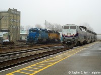 The short lived (on GEXR) LLPX 2263 (Blue) and 2236 (still on the property in 2017) wait for a crew to board for 580 while the Chicago bound "International" arrives to board passengers at Kitchener on a cool and foggy spring morning. I only had my Digital SLR a month before the Amtrak trains stopped but I made sure to photograph as many as I could. I followed the train to work from Guelph to Waterloo every day so it was easy - as long as you only planned to shoot it once.