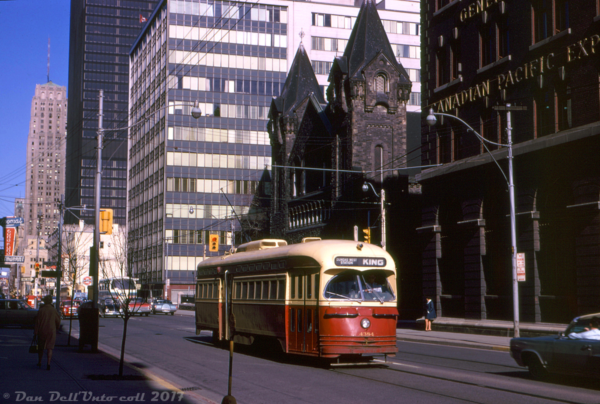 Toronto Transit Commission PCC 4384 passes through the downtown core on King Street, heading westbound just after crossing Simcoe on a King car bound for Dundas West Station.

It's seen passing the Canadian Pacific Express (originally the Dominion Express Company) offices, part CP's large freight shed complex built in 1914 that dealt with Less-Than-Carload freight and cargo forwarding (transloading between boxcars and trucks for local delivery) located in the King-Simcoe-Wellington-Front area. As other mail express companies came on the scene, along with containerization, railroads moved away from handling LCL freight and the Simcoe St. complex was closed and demolished a few years later in 1977. The property was redeveloped and eventually became home to the new Roy Thompson Hall. St. Andrew's Presbyterian church just behind the streetcar still exists today.

Original photographer unknown, Kodachrome slide from Dan Dell'Unto collection.