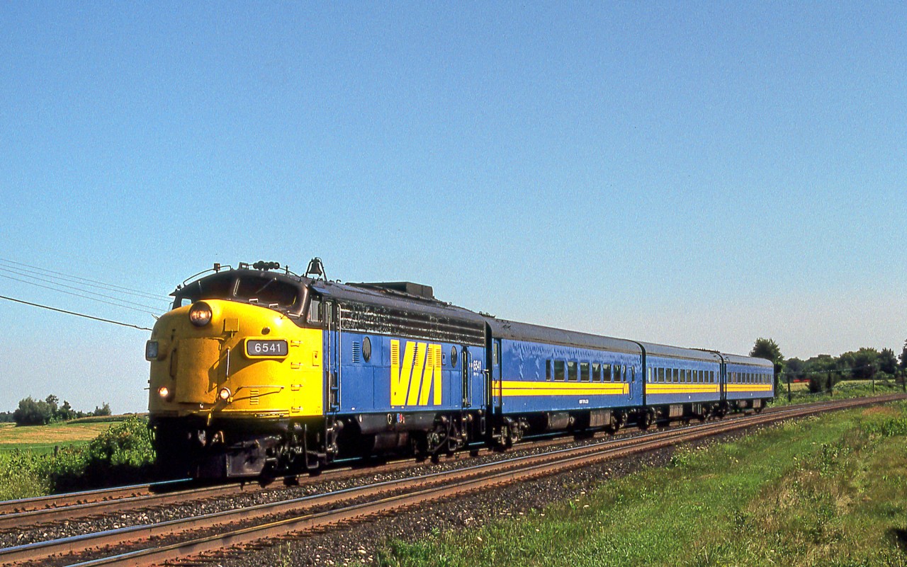 VIA 6541 with its short passenger train is in Brantford, Ontario on July 29, 1987.