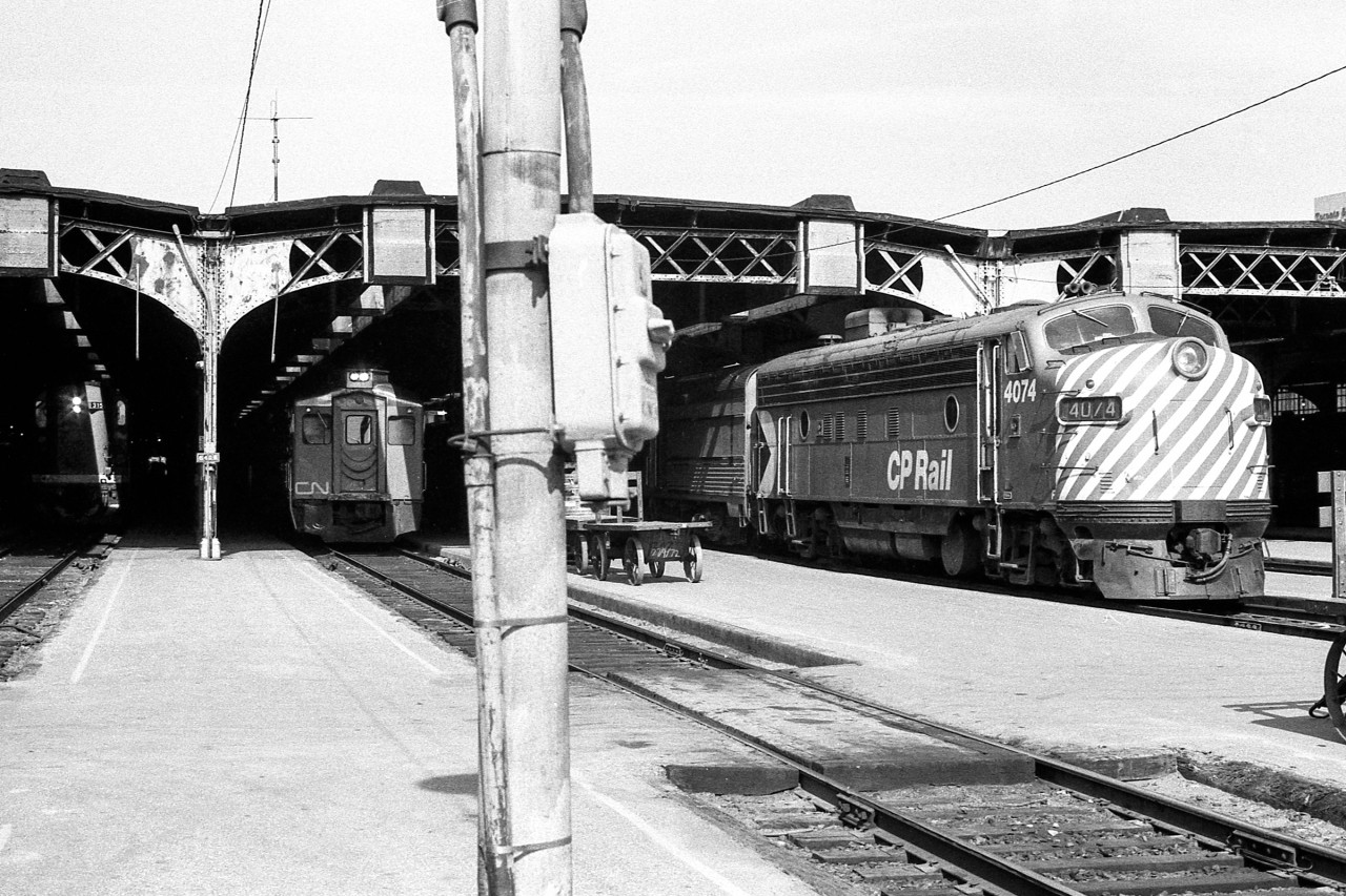 A CN RS-18, a CN RDC, and CP 4074 share this scene at Toronto Union Station in June (Date given is approximate) 1972.