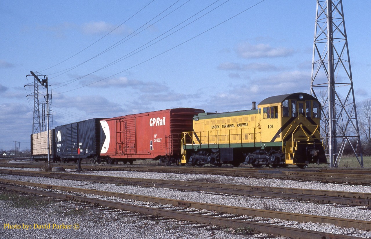Essex Terminal S-1 101 has three cars in tow including CP202327, a half plug door/half sliding door 50' XM box and an N&W Box both with no graffiti and a load of lumber by the old approach signal for Lakeshore Jct.