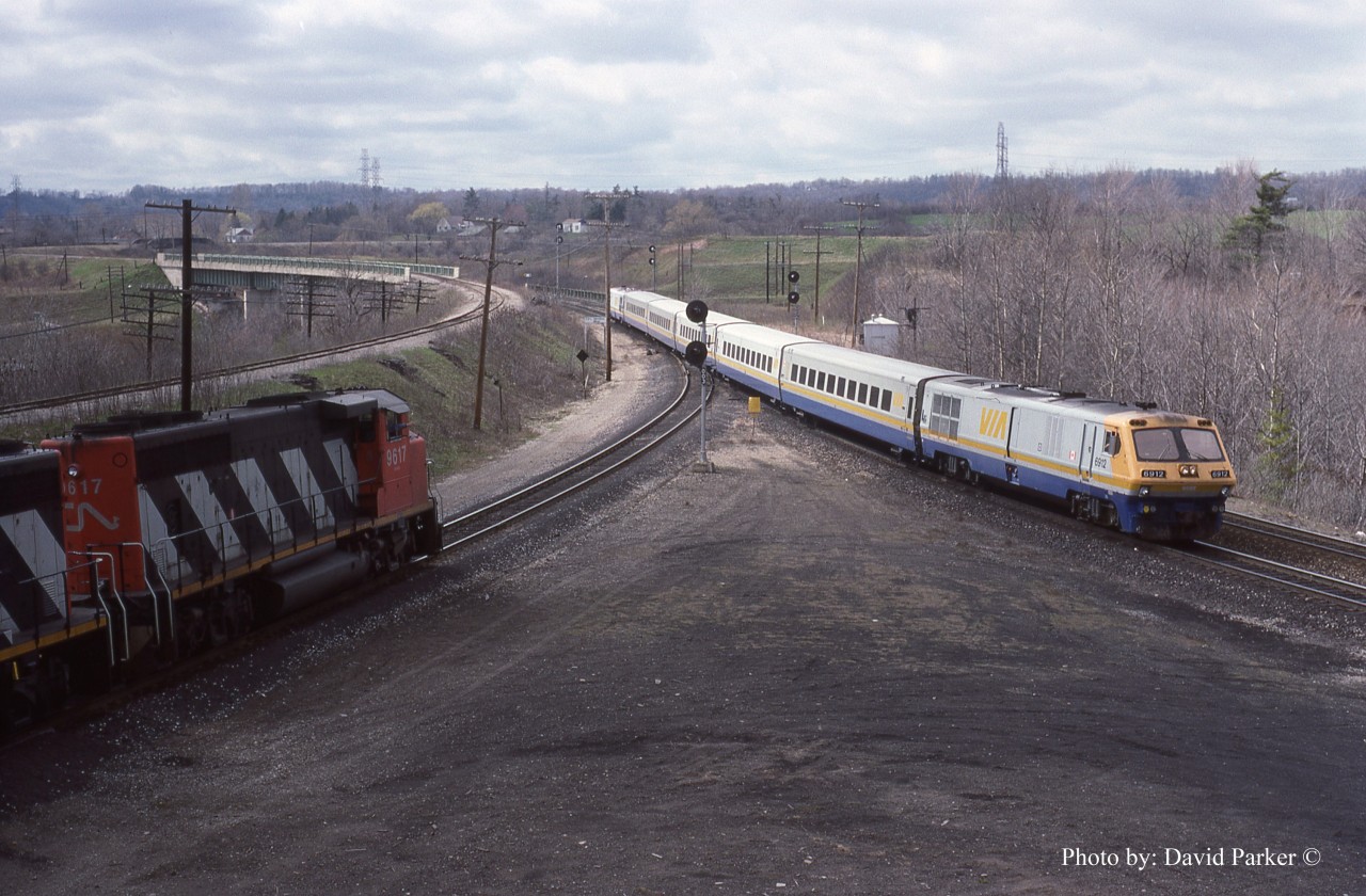 An as designed to operate (Engine on both ends) LRC set coasts through Hamilton Jct with VIA #72 on April 14th 1988 as a CN freight waits on the Cowpath to head West.  Yes, the Cowpath is the actual track designation. If a train requires an authority or a Foreman gets a TOP, the CTC computer shows it as such.