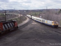  An as designed to operate (Engine on both ends) LRC set coasts through Hamilton Jct with VIA #72 on April 14th 1988 as a CN freight waits on the Cowpath to head West.  Yes, the Cowpath is the actual track designation. If a train requires an authority or a Foreman gets a TOP, the CTC computer shows it as such. 