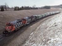  A trio of standard cab SD40's 5042-5082-5084 climbs the grade passing beneath the CP Belleville Sub just West of Beare Siding (Beare is now a spur as the West switch has been removed)