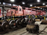 So long...farewell...2 more SD40-2's that are headed east for scrap are in having final adjustments made for their safe to travel inspections. In the foreground sits a GE AC traction motor with GE wheels lined up in the rack behind it.
